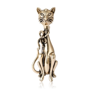 Retro gold cat brooch with bow tie ornament on white background for coat or dress decoration