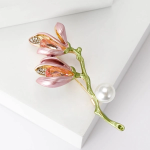 Elegant magnolia flower brooch with pink petals, pearls and crystals on white stone base