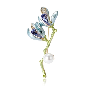 Elegant magnolia flower brooch with blue crystals, white pearl and green enamel stem