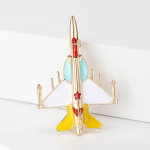 Macro detail of the elegant matte enamel fighter plane brooch with golden base