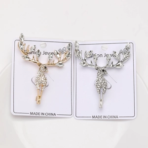 Detail of silver and gold elk brooches with rhinestones on fashion jewelry cards