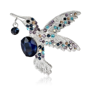 Broche colibri exquise avec pierres bleues et strass colorés sur monture argentée chic