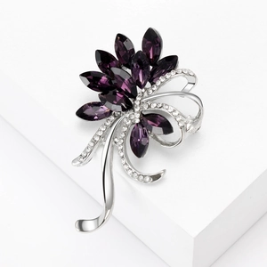 Detail of purple crystal orchid brooch with silver finish and sparkling rhinestones