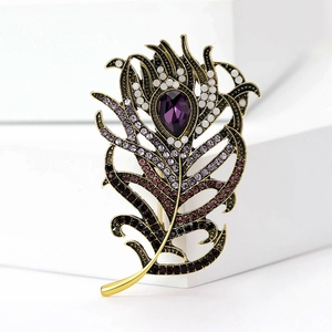 Detailed macro shot of vintage peacock feather brooch with purple gemstone and crystals