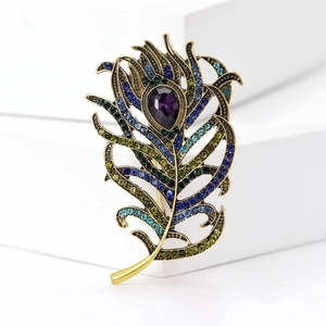 Macro detail of a vintage peacock feather brooch with purple stone and colorful crystals