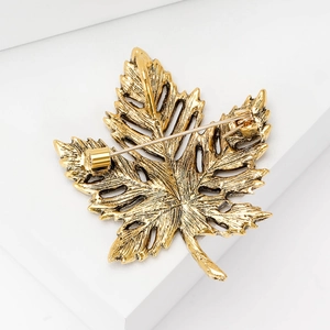 Vintage maple leaf brooch in antique gold metal with rhinestones and pin closure