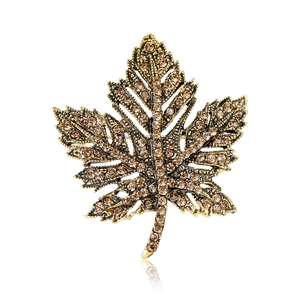Vintage maple leaf brooch with amber rhinestones on a classic golden metal base