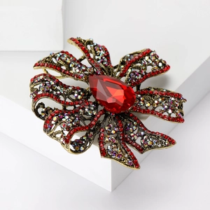 Vintage floral brooch with red crystal droplet and rhinestones on bronze hollow base