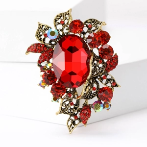 Vintage gold brooch with large red crystal and zircon accents in court style design