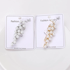 Detail of elegant cluster pearl ear cuffs in gold and silver finish with rhinestones