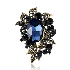 Elegant vintage baroque brooch with dark blue crystal and antique gold floral design