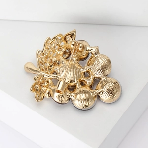Back view of gold grape brooch with secure metal pin clasp and detailed plating finish