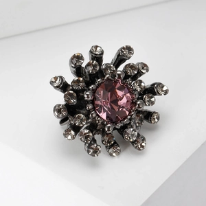 Detail of flower-shaped cocktail ring with pink crystal and white rhinestones on gunmetal