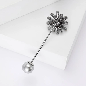 Vintage gun-black floral brooch with grey pearl on minimalist geometric background