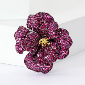 Elegant camellia flower brooch with deep pink zircons and golden center on white stand