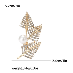 Elegant gold leaf brooch with crystals and pearl, stylish accessory for women jackets
