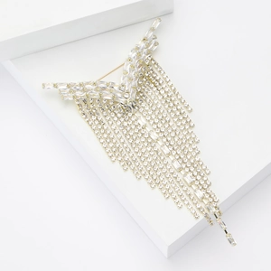 Macro detail of elegant Y-shaped tassel brooch with sparkling crystal rhinestones