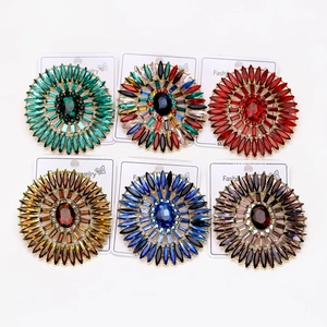 Detailed view of luxury sunflower brooches with colorful marquise crystals and rhinestones