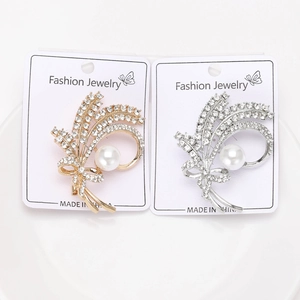 Macro detail of elegant wheat ear brooches with sparkling crystals and white pearls
