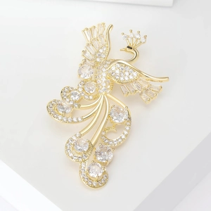 Luxury gold phoenix brooch with shimmering cubic zirconia crystals on white stand