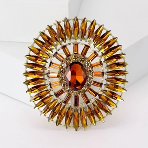 Macro detail of luxury amber crystal brooch with vintage gold setting on geometric block