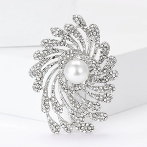 Close-up of elegant silver firework brooch with a large white pearl and sparkling crystals