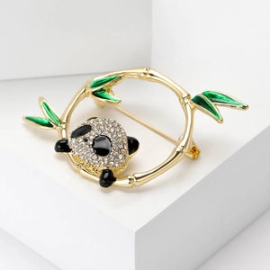 Detailed macro view of panda brooch with sparkling rhinestones and green enamel bamboo leaves