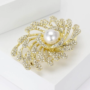 Macro detail of elegant rhinestone firework brooch with a large central faux pearl