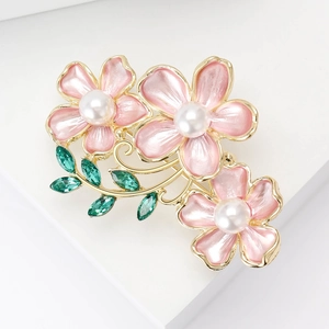 Elegant gold flower brooch with three pink enamel camellias, pearls and green crystals