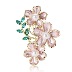 Elegant gold brooch with three pink camellias, white pearls and green crystal leaves