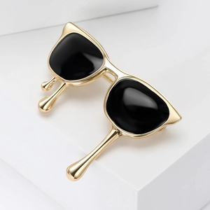 Detail of creative gold sunglasses brooch with black enamel and liquid drip design