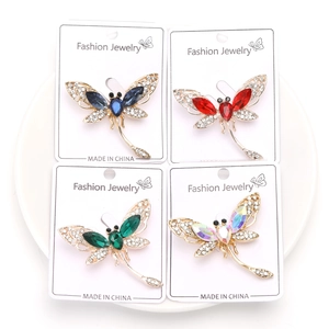 Detail view of four crystal dragonfly brooches in blue, red, green and iridescent colors