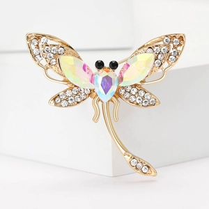 Macro view of gold dragonfly brooch featuring AB crystals and white rhinestones detail