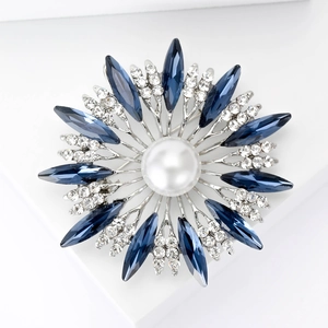Elegant sunflower brooch with navy blue crystals and a large white center pearl