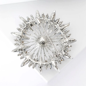 Detailed back view showing the safety pin clasp and metal texture of the sunflower brooch