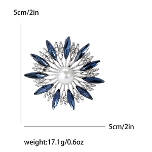 Elegant silver sunflower brooch with blue crystals and a central white pearl, 5cm size