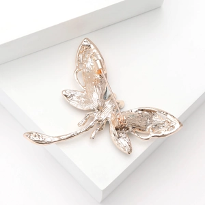 Detailed back view of a luxury dragonfly brooch showing the secure pin and gold plating