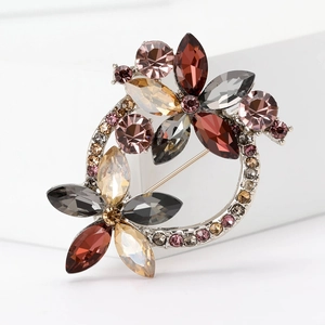Macro shot of silver wreath brooch with vibrant rhinestones and detailed gems