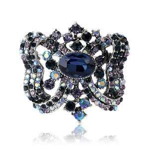 Vintage style crystal brooch featuring navy blue stones and an oval centerpiece