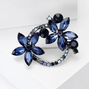 Macro shot of dark blue marquise crystals and multi-color rhinestones on a floral brooch