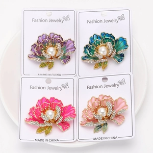 Vue détaillée de quatre broches pivoines en émail coloré avec perles et strass brillants