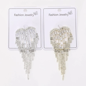 Close-up of heart-shaped alloy tassels with rhinestones in gold and silver finish