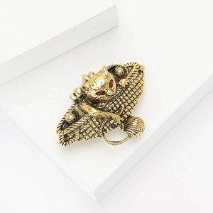 Retro gold alloy cat and basket brooch featuring red crystal eyes and textured finish