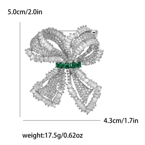 Bow brooch detail with micro-paved zircons and green gemstones, 5.0cm size display