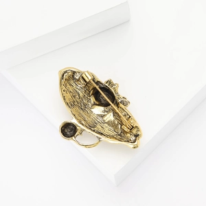 Detailed back view of vintage gold cat brooch showing safety pin clasp and antique texture