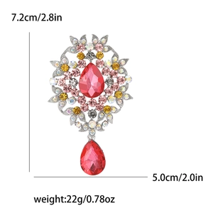 Detailed view of vintage alloy brooch with red crystal pendant showing size and weight specs