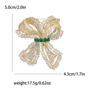 Bow brooch with sparkling zircons and green emerald accents, 5.0x4.3cm size