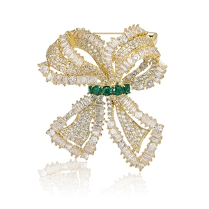 Exquisite gold bow brooch with micro-paved zircons and emerald green gemstone accents