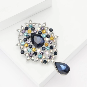 Vintage alloy brooch with navy blue teardrop crystal and colorful rhinestones on a pedestal