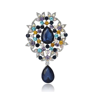 Vintage silver-tone brooch with pear-shaped blue gemstone and colorful rhinestones